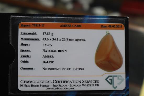 A yellow metal mounted natural amber pebble pendant, with GCS certificate dated 8/5/19.